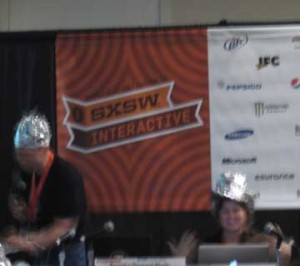 Panelists looking towards the future wearing hats made of tin foil