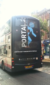Game advertising is extensive, visible here in an ad for Portal 2 on the back of a bus.