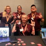 South by Texas State students pose in front of their information table at the Texas State University Innovation Lab reception.